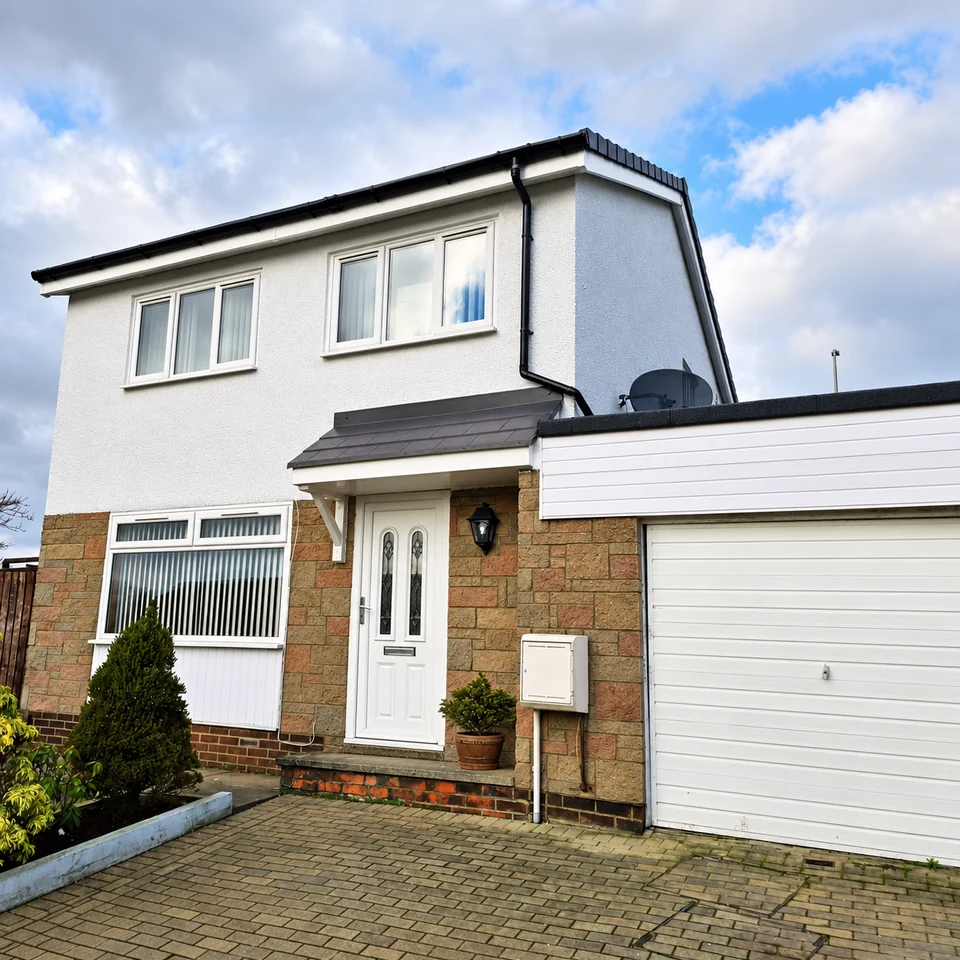 Light coated house exterior with contrasting dark trim